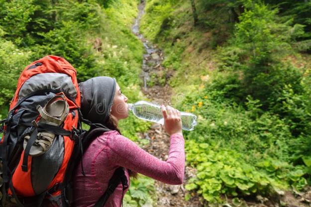 hiker-girl-drinking-water-woman-tourist-backpack-nature-young-tourist-woman-outdoor-forest-77470488
